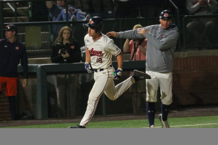 Ike Irish rounds third after hitting a home run for Auburn baseball against Alabama.